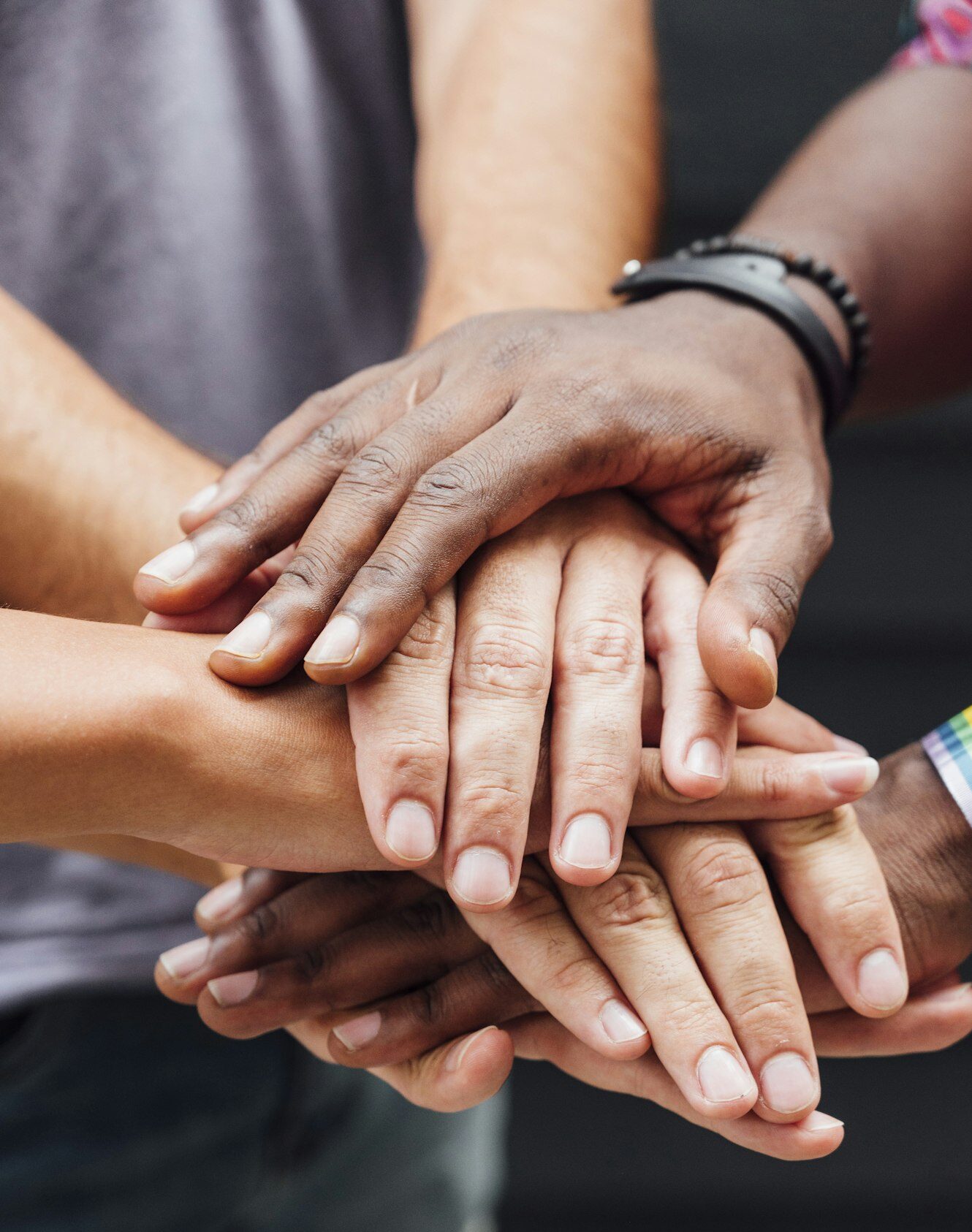 Different people putting hands in stack