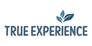 Text "TRUE EXPERIENCE" in blue capital letters with a stylized blue leaf above the "E" in "EXPERIENCE." The leaf design adds a natural or organic feel to the text.